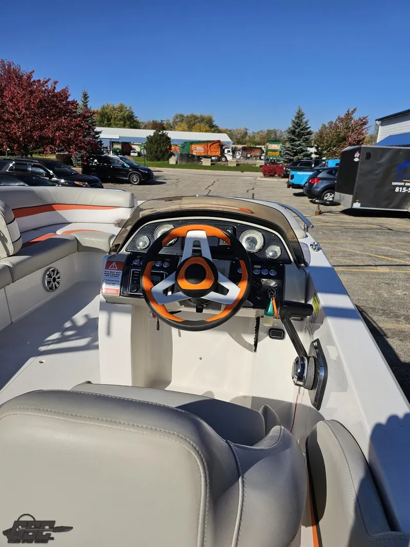 Slide: The Image of 2018 Starcraft Star Step 221 I/O boat dashboard with orange steering wheel. - 45