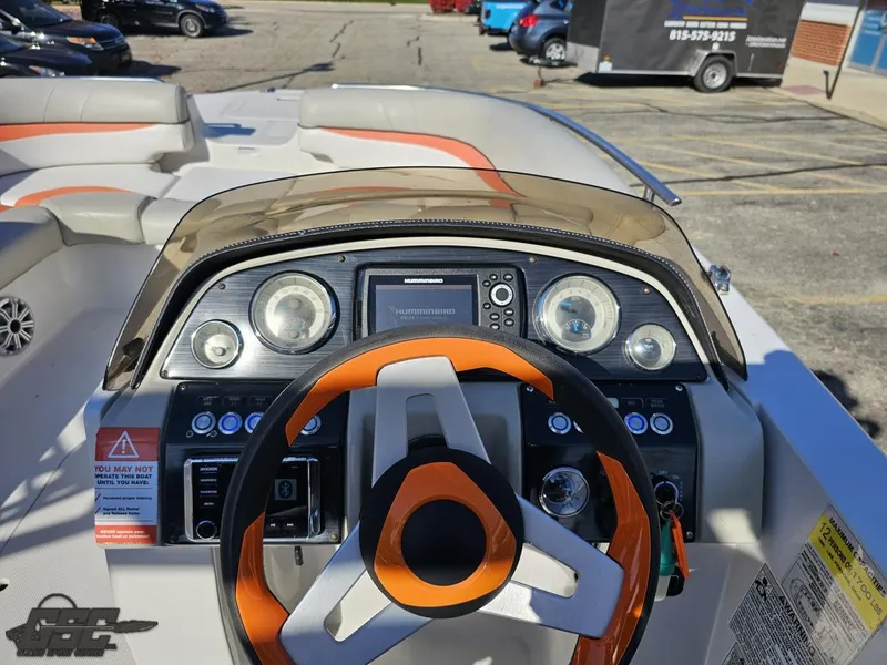 Slide: The Image of 2018 Starcraft Star Step 221 I/O boat dashboard with steering wheel and navigation controls. - 46