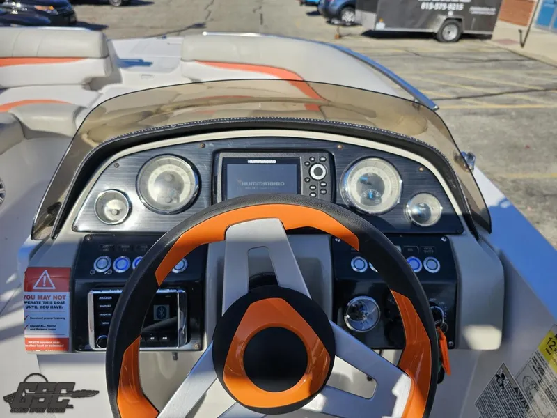 Slide: The Image of 2018 Starcraft Star Step 221 I/O boat dashboard with orange steering wheel and control panel. - 47