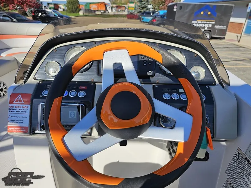 Slide: The Image of 2018 Starcraft Star Step 221 I/O boat dashboard with orange steering wheel. - 48