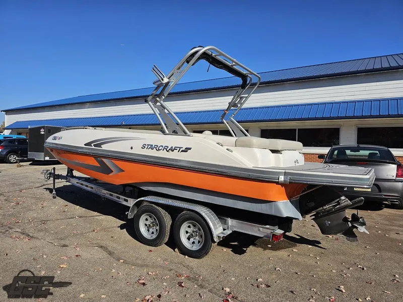 Slide: The Image of 2018 Starcraft Star Step 221 I/O boat on a trailer, parked outdoors. - 7