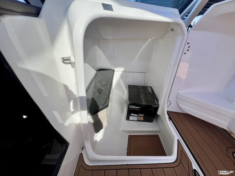 Slide: The Image of Storage compartment in 2025 Yamaha Boats 275SD, featuring sleek design and wooden flooring. - 8