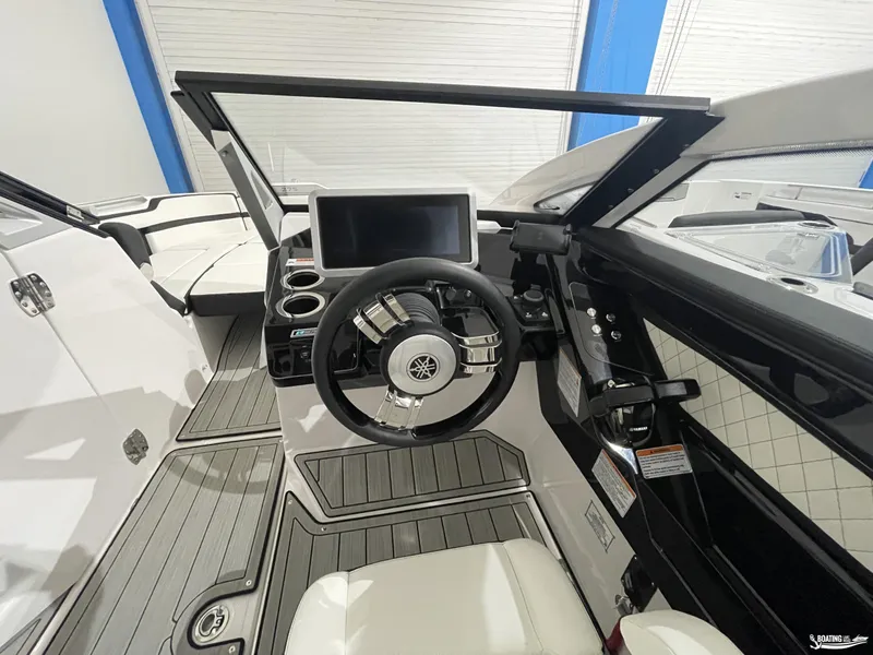 Slide: The Image of 2024 Yamaha Boats 275 SE cockpit with modern steering and dashboard design. - 12