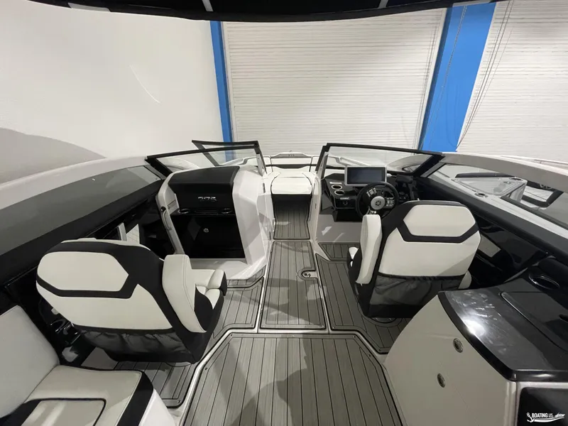 Slide: The Image of 2024 Yamaha Boats 275 SE interior with modern seating and sleek dashboard design. - 13