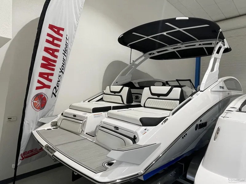Slide: The Image of 2024 Yamaha Boats 275 SE, sleek white design, showcased indoors with Yamaha branding. - 15