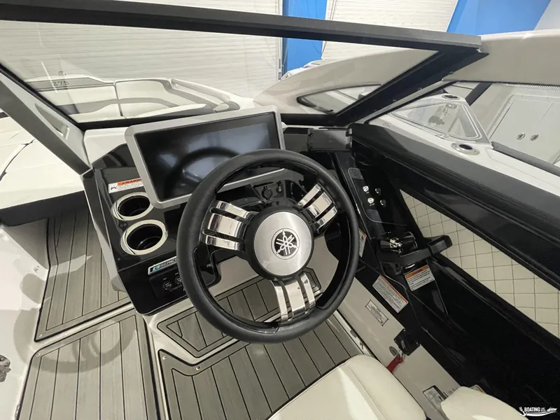 Slide: The Image of 2024 Yamaha Boats 275 SE dashboard with steering wheel and touchscreen display. - 8