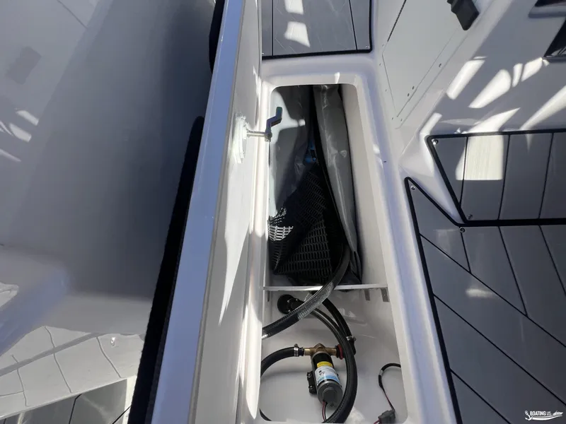 Slide: The Image of 2025 Yamaha Boats 252 XE storage compartment with equipment and hoses. - 3