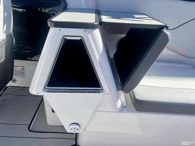 Slide: The Image of 2025 Yamaha Boats 252 XE interior storage compartment with open hatch. - 4
