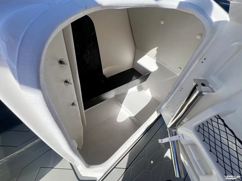 Slide: The Image of Interior storage compartment of 2025 Yamaha Boats 252 XE, featuring sleek design and ample space. - 6