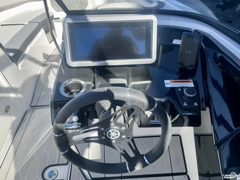 Slide: The Image of 2025 Yamaha Boats 252 XE dashboard with steering wheel and touchscreen display. - 7