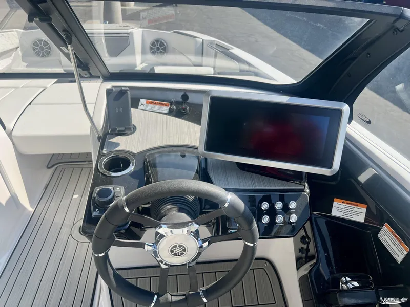 Slide: The Image of 2025 Yamaha Boats 222SE dashboard with steering wheel and touchscreen display. - 2