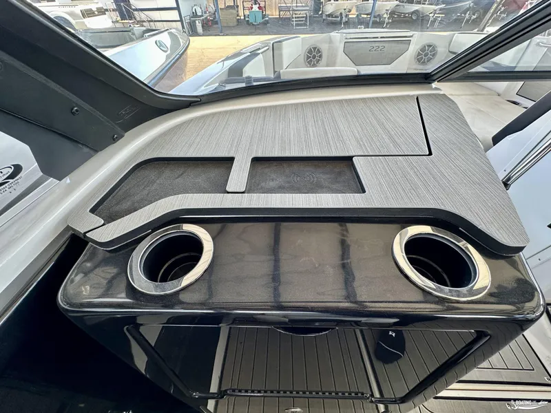 Slide: The Image of 2025 Yamaha Boats 222SE dashboard with cup holders and sleek design. - 7