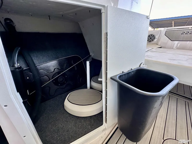 Slide: The Image of Interior storage compartment of 2025 Yamaha Boats 222SE with trash bin. - 8