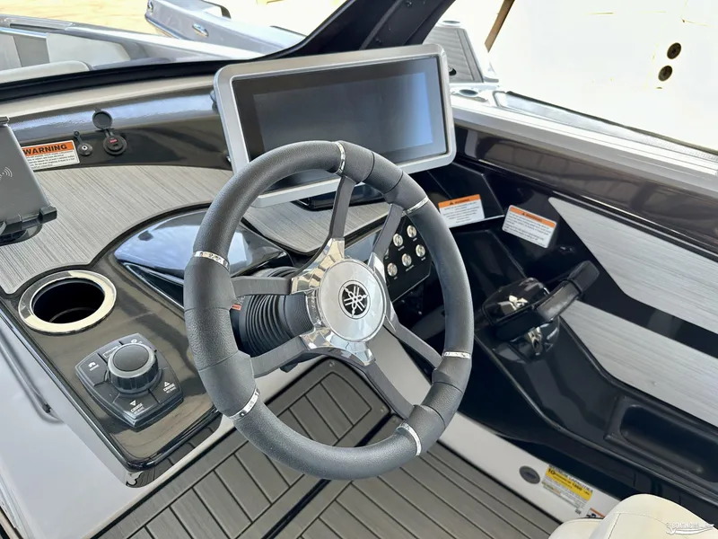 Slide: The Image of 2025 Yamaha Boats 222SE dashboard with steering wheel and touchscreen display. - 9