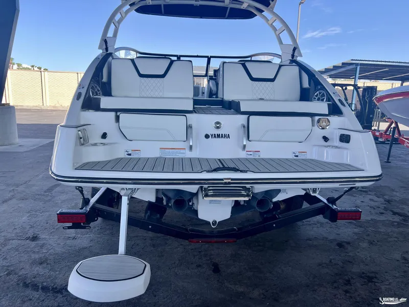 Slide: The Image of 2024 Yamaha Boats 252 SD, rear view, showcasing swim platform and seating. - 4