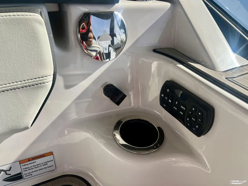 Slide: The Image of 2024 Yamaha Boats 252 SD interior console with controls and cup holder. - 7