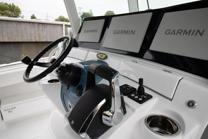 Slide: The Image of 2025 HCB 42 Lujo boat helm with Garmin displays and steering wheel. - 10