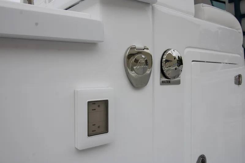 Slide: The Image of 2025 HCB 42 Lujo boat detail showing water access and electrical outlet. - 19