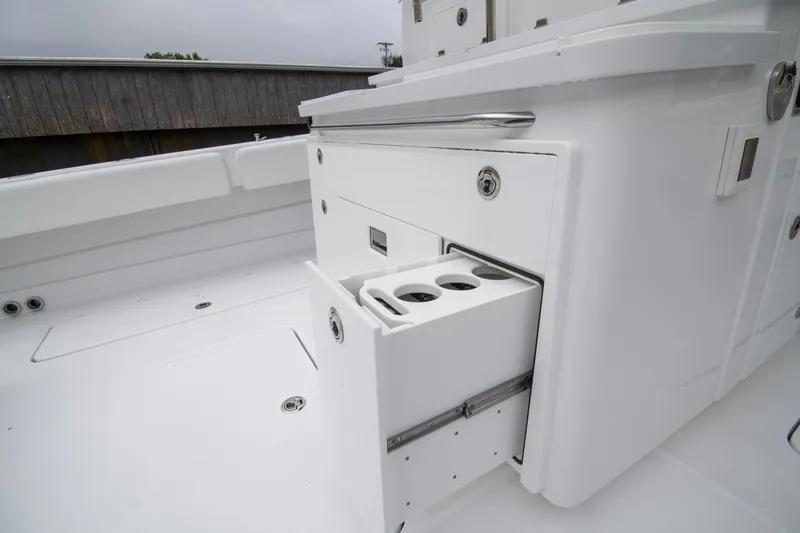Slide: The Image of HCB 42 Lujo 2025 boat with open storage compartment and cup holders. - 31