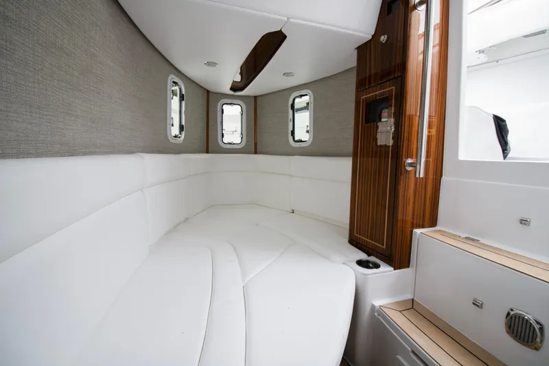 Slide: The Image of Luxurious interior of 2025 HCB 42 Lujo boat with white seating and wood accents. - 36