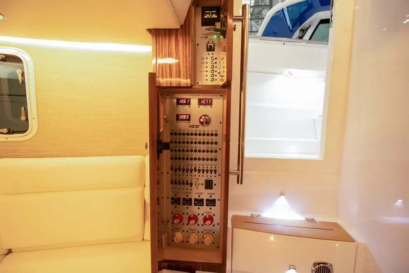 Slide: The Image of Control panel inside 2025 HCB 42 Lujo boat, featuring modern instrumentation and seating. - 46