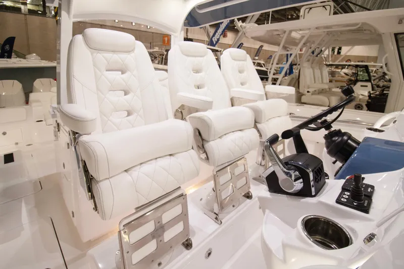 Slide: The Image of Luxury seating on 2025 HCB 42 Lujo boat, featuring white leather and modern controls. - 48
