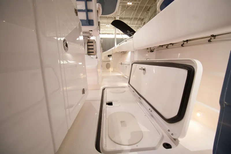 Slide: The Image of 2025 HCB 42 Lujo boat interior with open storage compartment, sleek white design. - 49