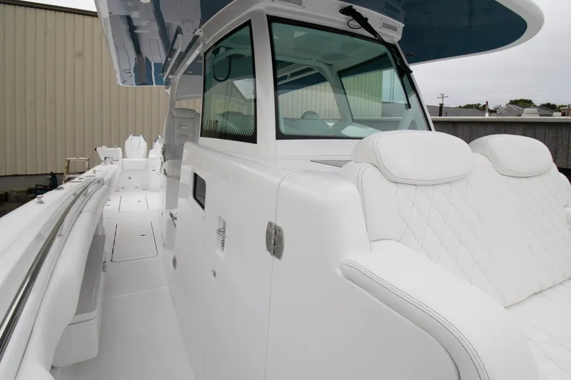 Slide: The Image of 2025 HCB 42 Lujo boat with luxurious white seating and sleek design. - 9