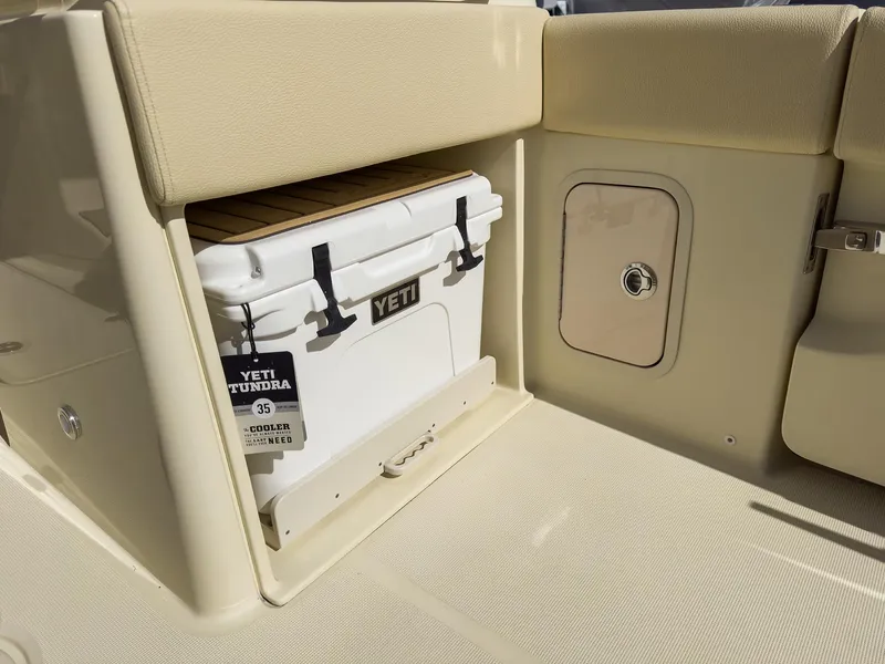 Slide: The Image of 2024 Chris-Craft 24 CALYPSO boat with Yeti Tundra cooler storage compartment. - 10