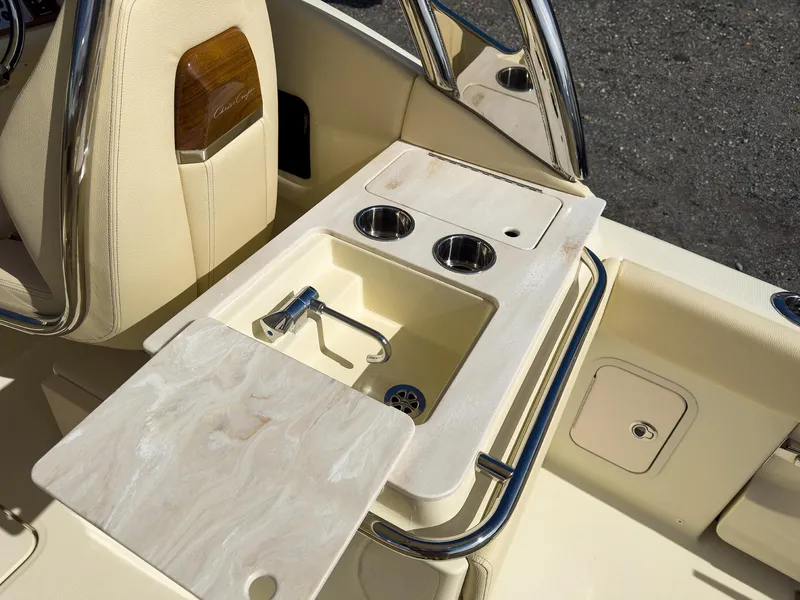 Slide: The Image of 2024 Chris-Craft 24 CALYPSO boat sink and cup holders in beige interior. - 11