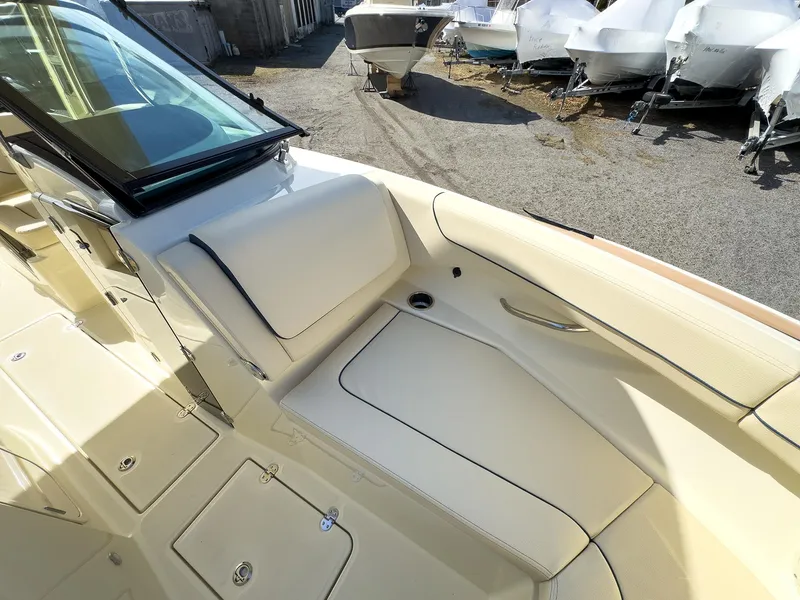Slide: The Image of 2024 Chris-Craft 24 CALYPSO boat interior with beige seating and storage compartments. - 12
