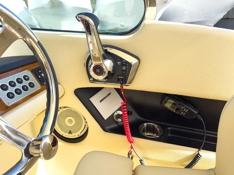 Slide: The Image of 2024 Chris-Craft 24 CALYPSO boat interior with steering wheel and control panel. - 14