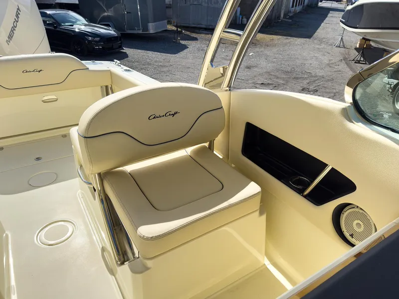 Slide: The Image of 2024 Chris-Craft 24 CALYPSO boat interior with beige seating and storage compartments. - 15
