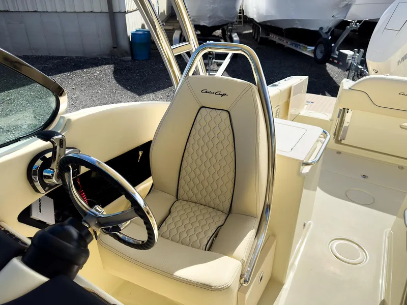 Slide: The Image of 2024 Chris-Craft 24 CALYPSO boat interior with luxurious captain's seat and steering wheel. - 16