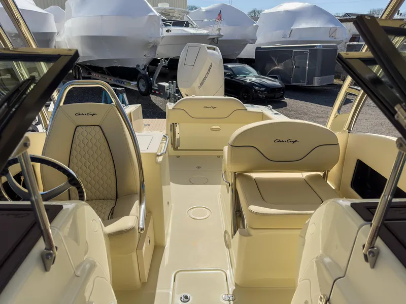 Slide: The Image of 2024 Chris-Craft 24 CALYPSO boat interior with luxurious seating and steering wheel. - 17