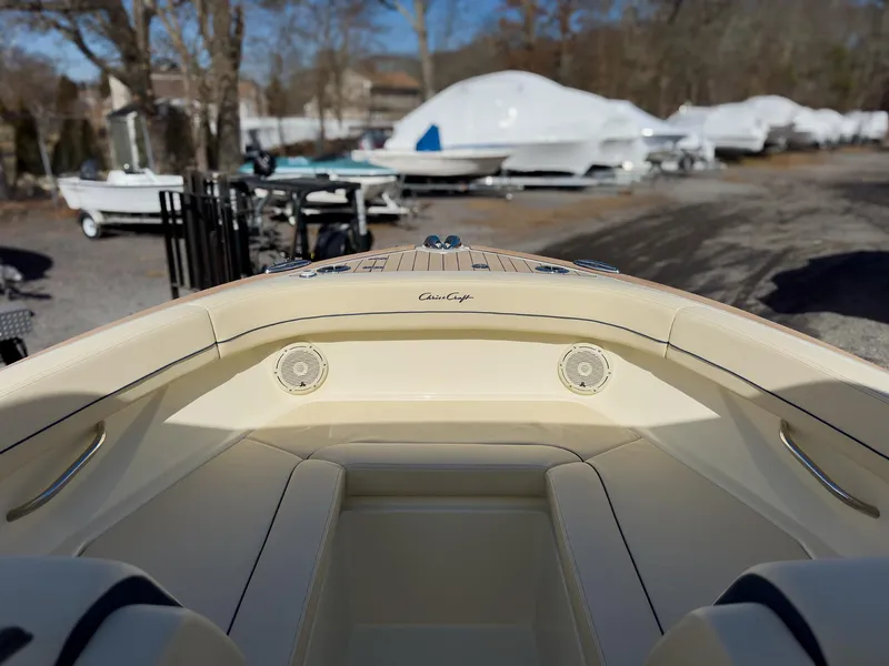 Slide: The Image of 2024 Chris-Craft 24 CALYPSO boat interior with beige seating and speakers. - 18