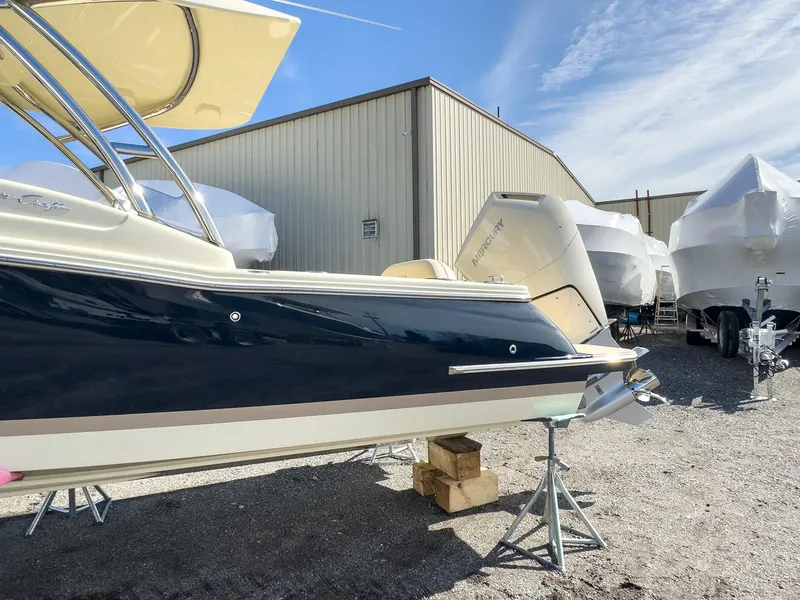 Slide: The Image of 2024 Chris-Craft 24 CALYPSO boat in storage yard with other covered boats. - 22