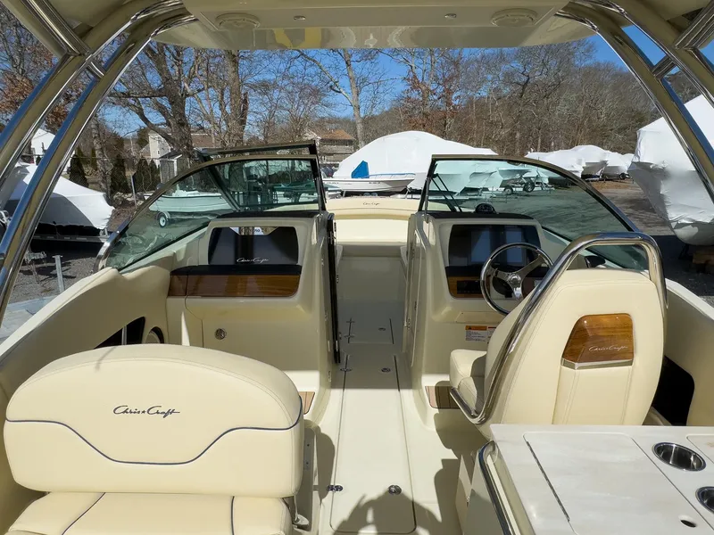 Slide: The Image of 2024 Chris-Craft 24 CALYPSO boat interior with beige seating and modern dashboard. - 24