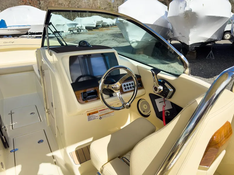 Slide: The Image of 2024 Chris-Craft 24 CALYPSO boat interior with steering wheel and dashboard. - 25