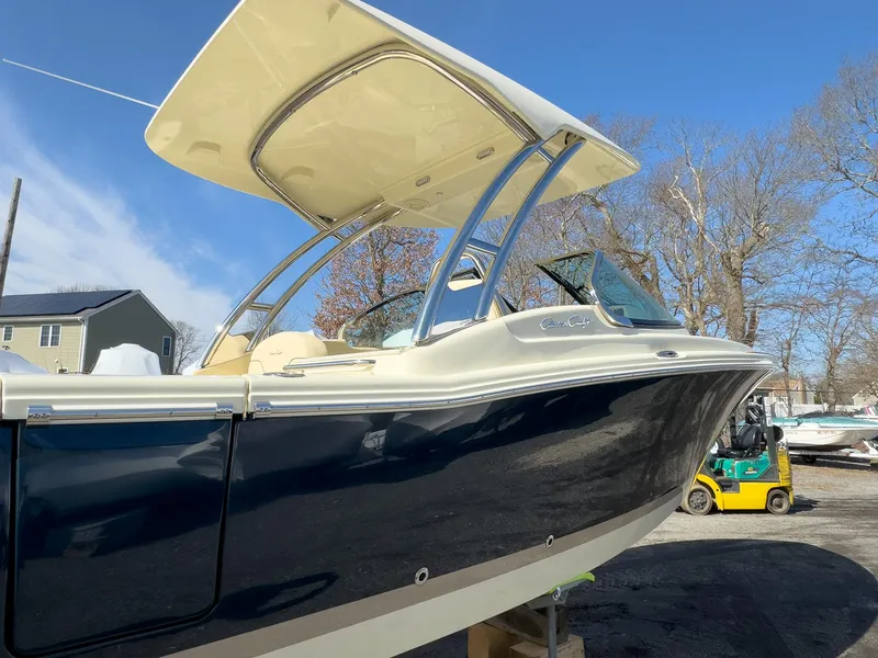 Slide: The Image of 2024 Chris-Craft 24 CALYPSO boat with hardtop, docked outdoors on a sunny day. - 26