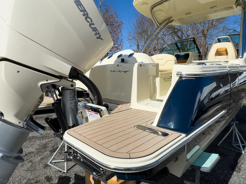 Slide: The Image of 2024 Chris-Craft 24 CALYPSO boat with Mercury outboard motor, rear deck view. - 27