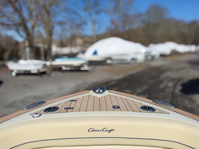 Slide: The Image of 2024 Chris-Craft 24 CALYPSO boat bow with teak decking and logo. - 4