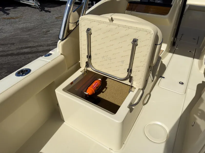 Slide: The Image of 2024 Chris-Craft 24 CALYPSO boat storage compartment with open lid. - 6
