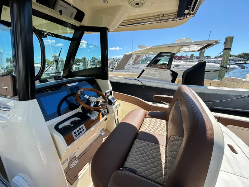 Slide: The Image of 2024 Chris-Craft Catalina boat interior with luxurious seating and modern dashboard. - 10