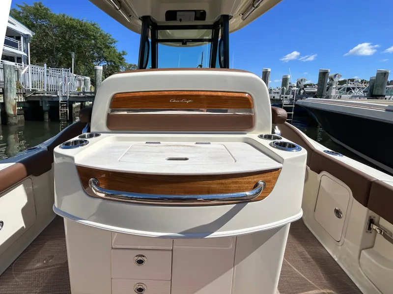 Slide: The Image of 2024 Chris-Craft Catalina boat interior with elegant wood accents and storage compartments. - 11