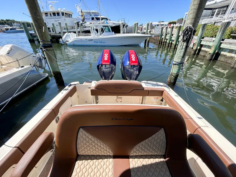 Slide: The Image of 2024 Chris-Craft Catalina boat with twin engines docked at a marina. - 13