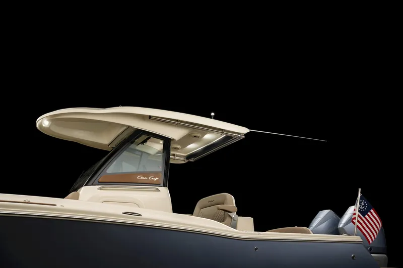 Slide: The Image of 2024 Chris-Craft Catalina boat with sleek design and American flag, side view. - 15