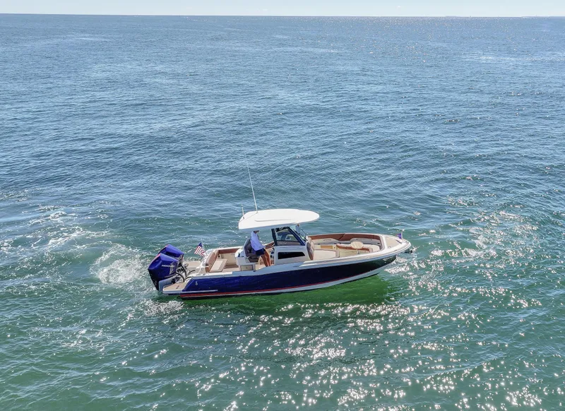 Slide: The Image of 2024 Chris-Craft Catalina boat cruising on open water. - 2