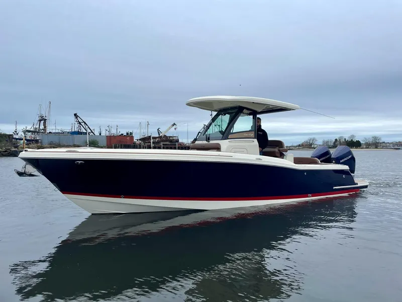 Slide: The Image of 2024 Chris-Craft Catalina boat on calm water, showcasing sleek design and modern features. - 4