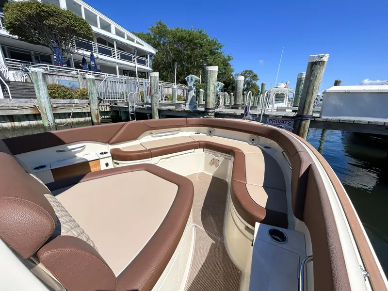 Slide: The Image of 2024 Chris-Craft Catalina boat with brown seating at a marina dock. - 6